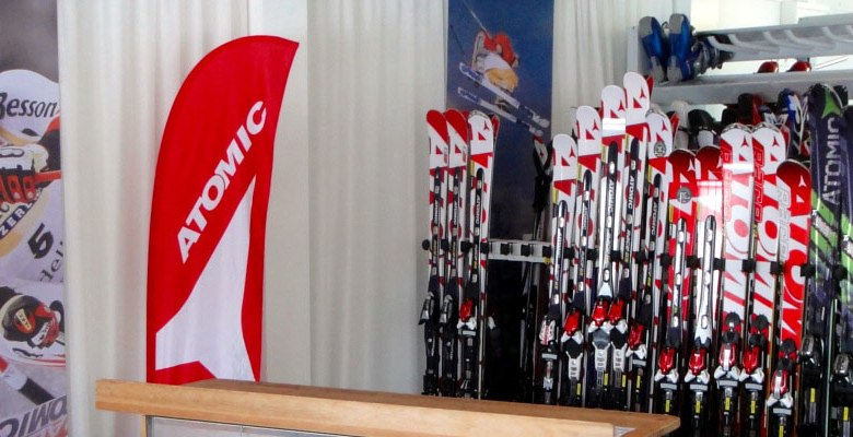 Ski rental with Atomic skis and advertising banner.